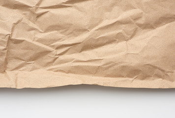 Fototapeta na wymiar piece of crumpled blank sheet of brown wrapping paper