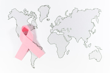 Obraz na płótnie Canvas World Cancer Day with ribbon symbol on world map background.