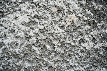 Texture of an old cracked concrete wall. Background image of a worn gray concrete surface