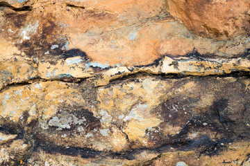 The texture of the stone overgrown with moss. Background image of a boulder