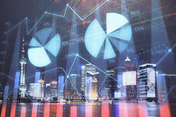 Financial graph on night city scape with tall buildings background double exposure. Analysis concept.