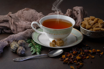 Tea hot drink on old background in composition on the table