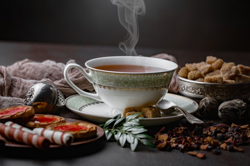 Tea hot drink on old background in composition on the table