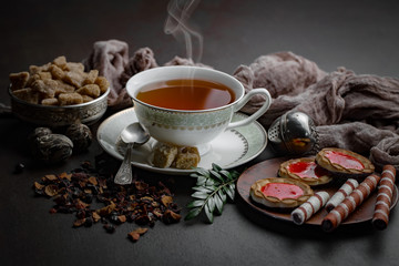 Tea hot drink on old background in composition on the table