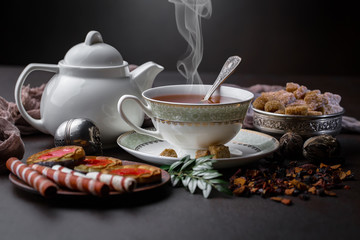 Tea hot drink on old background in composition on the table