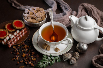 Tea hot drink on old background in composition on the table