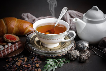 Tea hot drink on old background in composition on the table