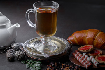 Tea hot drink on old background in composition on the table