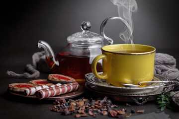 Tea hot drink on old background in composition on the table