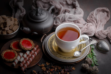 Tea hot drink on old background in composition on the table