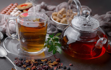 Tea hot drink on old background in composition on the table