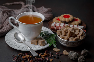 Tea hot drink on old background in composition on the table