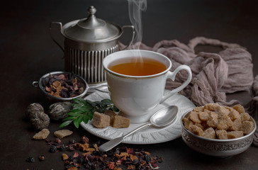 Tea hot drink on old background in composition on the table