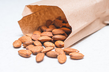 Almond nuts by weight in paper bags. Sprinkled nuts.