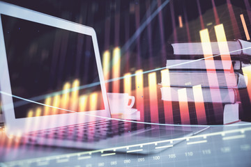 Forex graph hologram on table with computer background. Multi exposure. Concept of financial...