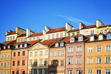 Old tenement house with facade buidling in sequence in Warsaw in old town. Windows in  complex building in Poland.