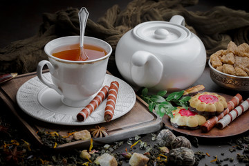 Tea hot drink on old background in composition on the table