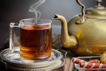 Tea hot drink on old background in composition on the table