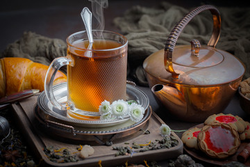 Tea hot drink on old background in composition on the table