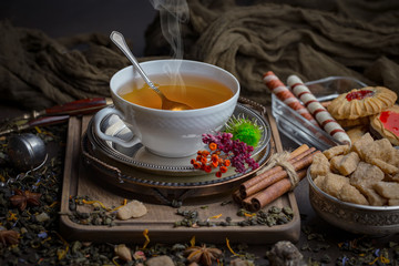Tea hot drink on old background in composition on the table