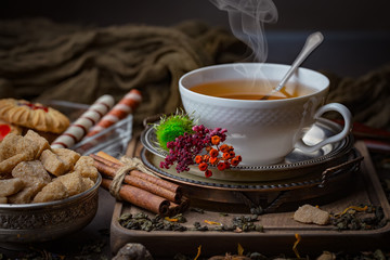 Tea hot drink on old background in composition on the table