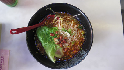 Closeup of noodle soup with cabbage and beans