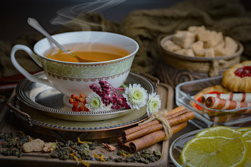 Tea hot drink on old background in composition on the table