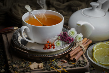 Tea hot drink on old background in composition on the table