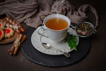 Tea hot drink on old background in composition on the table