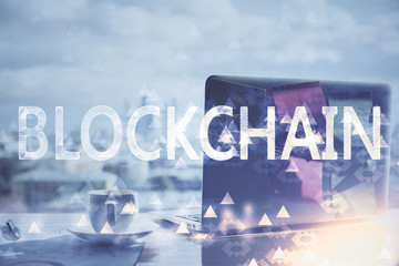 Double exposure of blockchain theme hologram and table with computer background. Concept of bitcoin crypto currency.