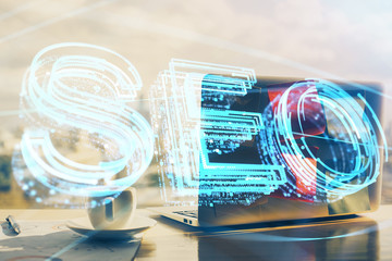 Multi exposure of table with computer and seo drawing hologram. Search optimization concept.