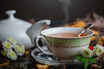 Hot tea in a cup with kitchen accessories 