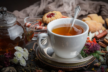 Tea hot drink on old background in composition on the table