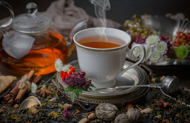 Tea hot drink on old background in composition on the table