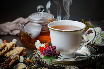 Tea hot drink on old background in composition on the table