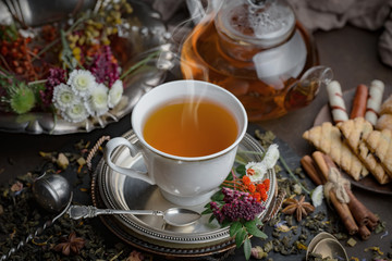Tea hot drink on old background in composition on the table