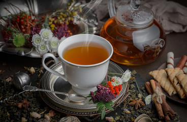 Tea hot drink on old background in composition on the table