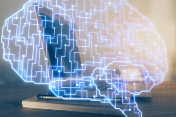 Multi exposure of work table with computer and brain hologram. Brainstorm concept.