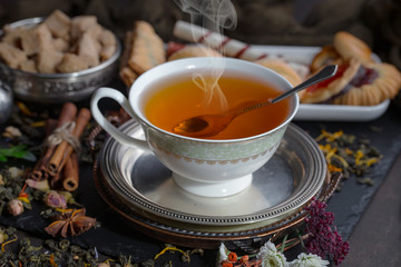Tea hot drink on old background in composition on the table