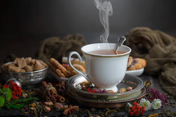 Tea hot drink on old background in composition on the table
