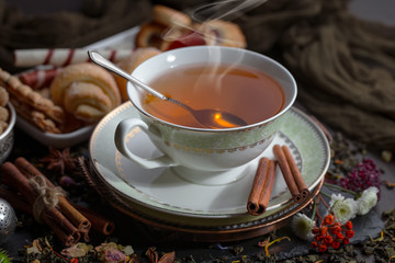 Tea hot drink on old background in composition on the table