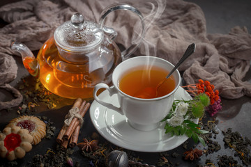 Hot tea in a cup with kitchen accessories 