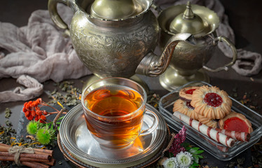 Tea hot drink on old background in composition on the table