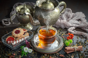Tea hot drink on old background in composition on the table