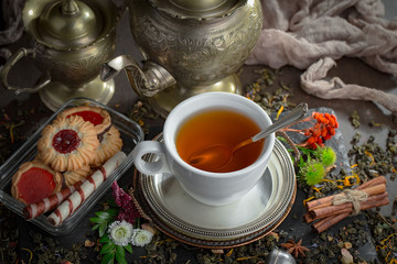 Tea hot drink on old background in composition on the table