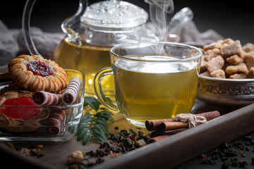 Tea hot drink on old background in composition on the table