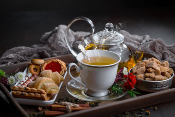 Tea hot drink on old background in composition on the table