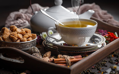 Tea hot drink on old background in composition on the table