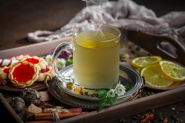 Tea hot drink on old background in composition on the table