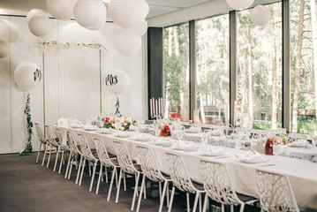Decorated hall with a festive table in white tones.